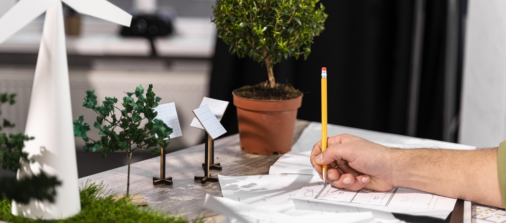 side-view-man-working-eco-friendly-wind-power-project-with-paper-plans